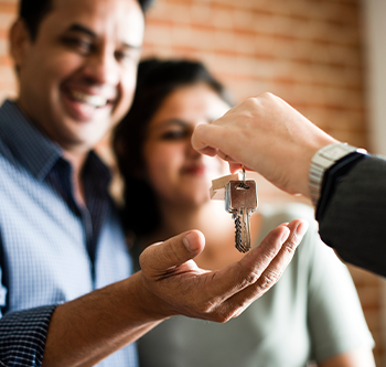 Agent giving key to couple